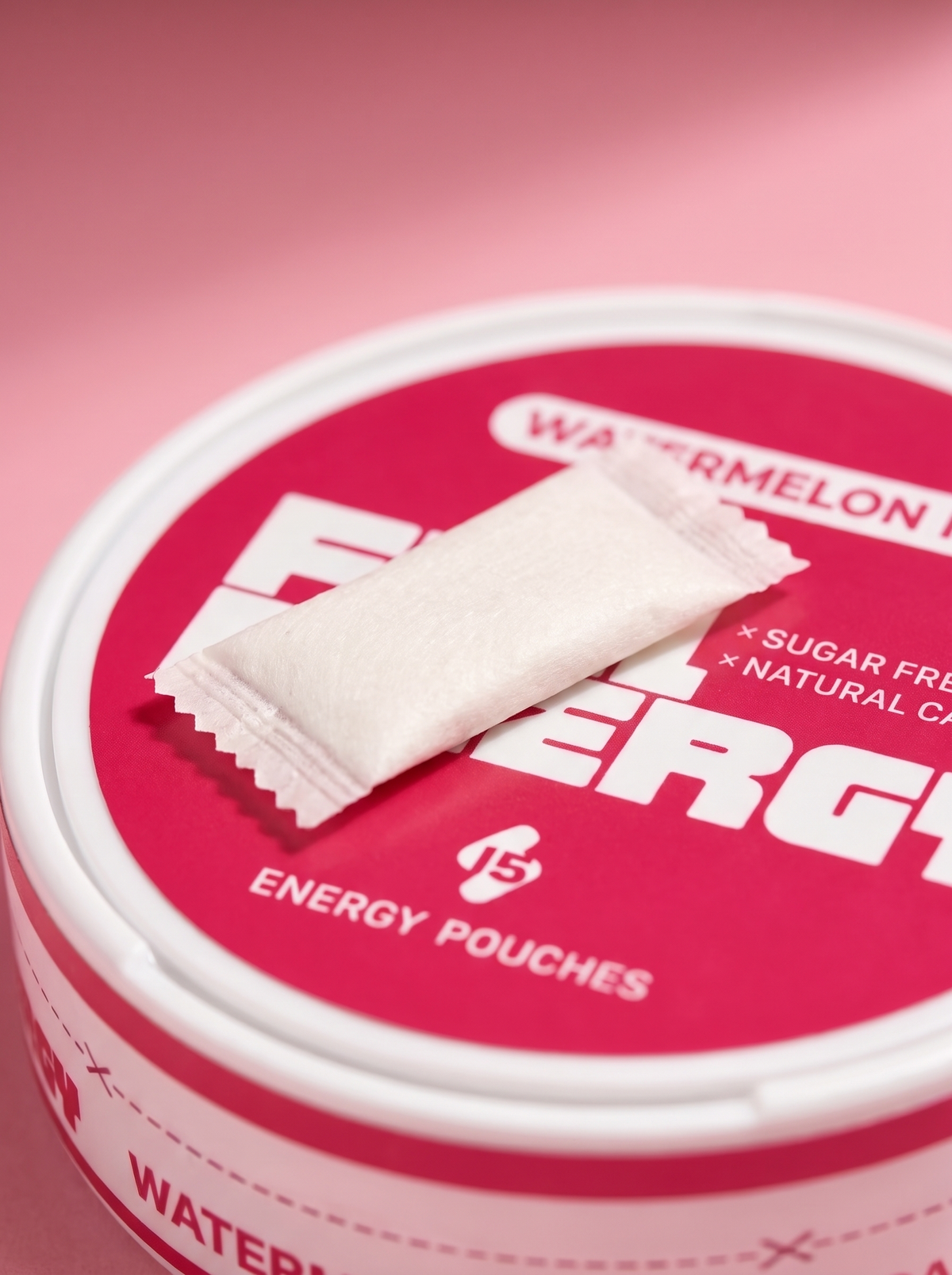 Close-up of a single FUEL Energy Watermelon Ice caffeine pouch resting on the tin lid