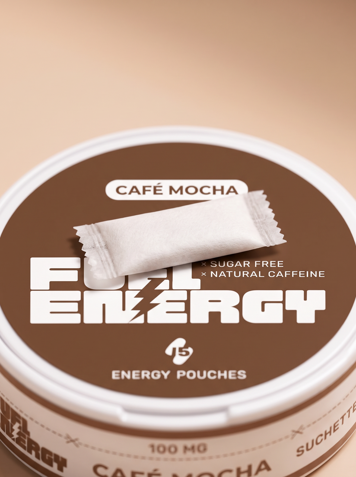 Close-up of a single FUEL Energy Café Mocha caffeine pouch resting on the tin lid